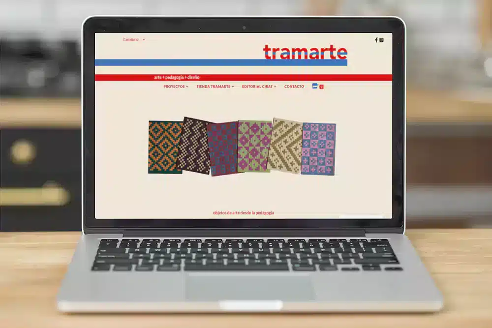 Imagen de un ordenador mostrando la home de la web y tienda online de Tramarte